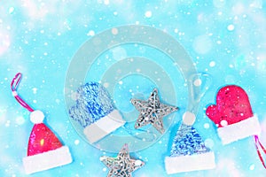 Christmas composition from Christmas tree toys. White decor on a blue background. Copy space, flat lay, top view.