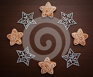 Christmas composition. Cookies and stars. Gingerbread and snowflakes on a wooden background. The decoration of Christmas wreaths.
