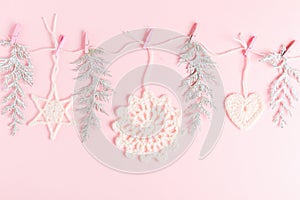 Christmas composition of crocheted white snowflakes and stars on pink background. Top view, flat lay, copy space.