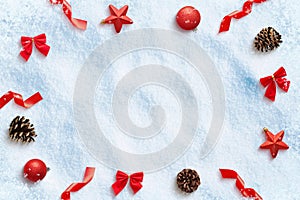 Christmas composition with decorations on snow. Copy space in the middle