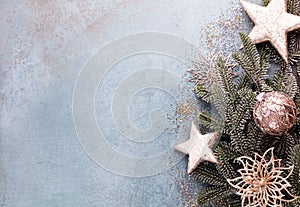 Christmas composition fir tree branches, gold sterne on blue background