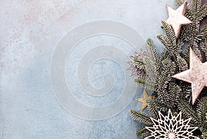 Christmas composition fir tree branches, gold sterne on blue background