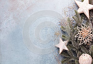 Christmas composition fir tree branches, gold sterne on blue background