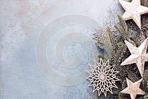 Christmas composition fir tree branches, gold sterne on blue background