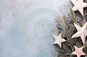 Christmas composition fir tree branches, gold sterne on blue background