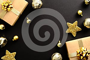 Christmas composition. Flat lay gifts, golden balls star decoration on dark black background. Merry Christmas and Happy New Year