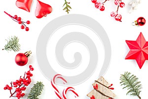 Christmas composition frame. Christmas tree branches and red decorations on white background. Flat lay, top view with copy space