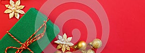 Christmas composition. Gift box, golden toys on red background. new year concept. Greeting card, xmas celebration 2020. Flat lay,