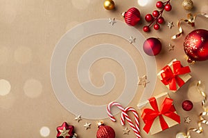 Christmas composition. Gift boxes, holiday decorations on golden background top view. Flat lay