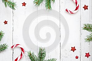 Christmas composition. Christmas gift, candy cane and fir tree branches. Top view, flat lay. photo