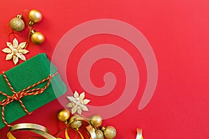 Christmas composition. gift, golden toys lying on red background. new year concept. Greeting card, xmas celebration 2020
