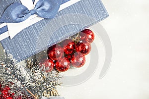 Christmas composition. Gift, for tree branches, red balls decorations on white background.