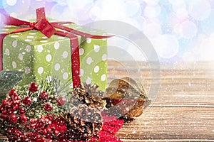 Christmas composition. Gift, for tree branches, red balls decorations on wooden background.