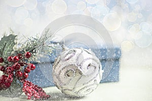 Christmas composition. Gift, for tree branches, white balls decorations on bokeh background.