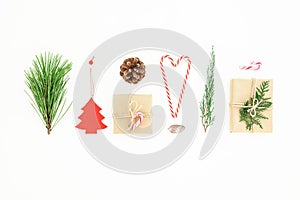 Christmas composition of gifts with candy cane, pine branch and cone on white background. New year concept