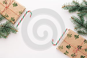 Christmas composition. Gifts, fir branches, red and green Christmas candies, decorations on a white background. The concept of