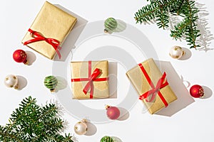 Christmas composition. Gifts, fir tree branches and balls decorations on white background. Christmas, winter, new year concept.