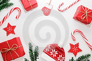 Christmas composition. Gifts, fir tree branches, red decorations on white background. Christmas, new year concept. Flat lay