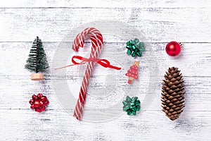 Christmas composition. Gifts, fir tree and cone, candy canes on wooden background. Christmas, winter, new year concept