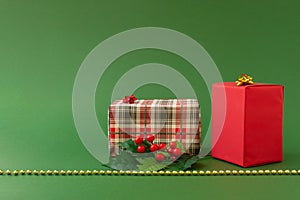 Christmas composition with gifts and holiday decorations on green background. Merry Christmas, New Year, winter concept