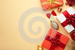 Christmas composition. Gifts, red decorations on beige background. New year concept