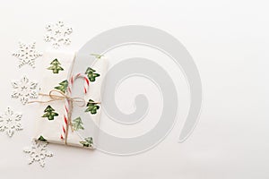 Christmas composition. Gifts, red and green Christmas candies, snowflakes on a white background. The concept of Christmas, winter