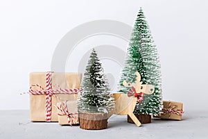 Christmas composition. Gifts, small tree, branches and craft DIY decorations on white background. New year concept