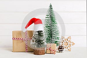 Christmas composition. Gifts, small tree, branches and craft DIY decorations on white background. New year concept