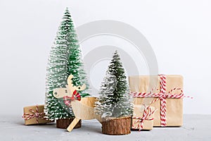 Christmas composition. Gifts, small tree, branches and craft DIY decorations on white background. New year concept