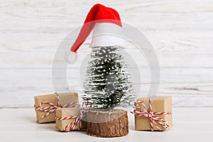 Christmas composition. Gifts, small tree, branches and craft DIY decorations on white background. New year concept