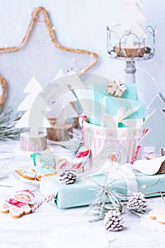 Christmas composition with gingerbread cookies, gift boxes, wooden fir trees in background