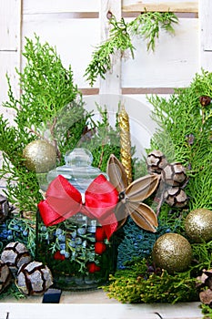 Christmas composition with a glass jar with a red bow