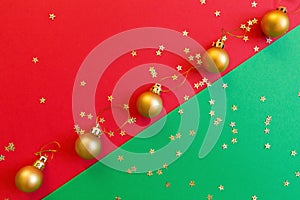 Christmas composition. Golden toy on red and green background with golden confetti. new year concept. Greeting card, xmas