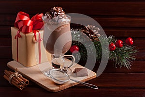 Christmas composition with hot cocoa, gift and fir-tree branch