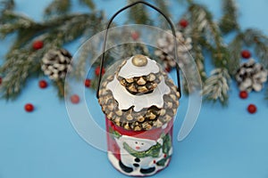 Christmas composition lantern snowman on the blue background of a winter spruce. Close-up. The concept of Christmas and New Year.