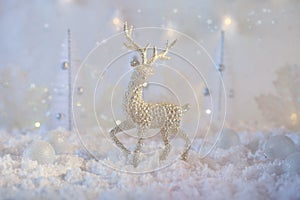 Christmas composition made of Christmas balls and figurine of reindeer on blue winter background. Minimal styled holiday card.