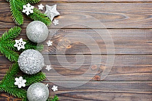 Christmas composition made of fir tree, balls and different decorations on wooden background. Top view of New Year Advent concept