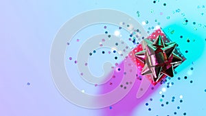 Christmas composition neon. Xmas gift box with shine lights. Holiday decoration on neon abstract gradient backdrop. New