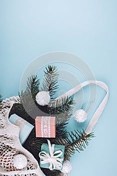 Christmas composition. New Year or Christmas flat lay, top view with trend eco friendly modern cotton net bag with fir branches,