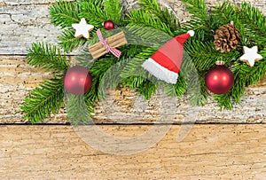 Christmas composition with ornaments and fir branch on rustic wood, copy space