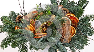 Christmas composition of pine branches, wine corks, orange slices and pine cones