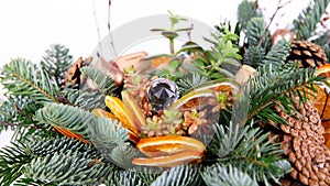 Christmas composition of pine branches, wine corks, orange slices and pine cones