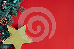 Christmas composition of pine cones, spruce branches and stack of gift boxes on red background