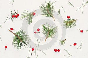 Christmas composition. Pine green branches with red berries on white background. Christmas background, top view, horizontal image