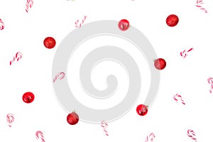 Christmas composition with red decoration and candy cane isolated on white background. Flat lay