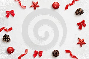 Christmas composition with red decorations on clean surface wirh copy space in the middle