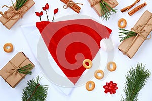 Christmas composition with a red New Year\'s cap in the center and decor around