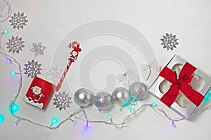 Christmas composition of red and silver decorations, gift box with ribbon bow, flatlay
