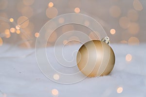 Christmas composition with red wooden Santa Claus sleigh, fir cone and Xmas tree balls over blurred light background