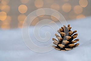 Christmas composition with red wooden Santa Claus sleigh, fir cone and Xmas tree balls over blurred light background